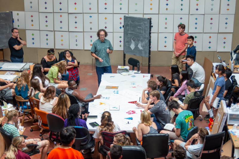 Jim Bassett, Associate Professor, teaching a class gathered in Burchard.